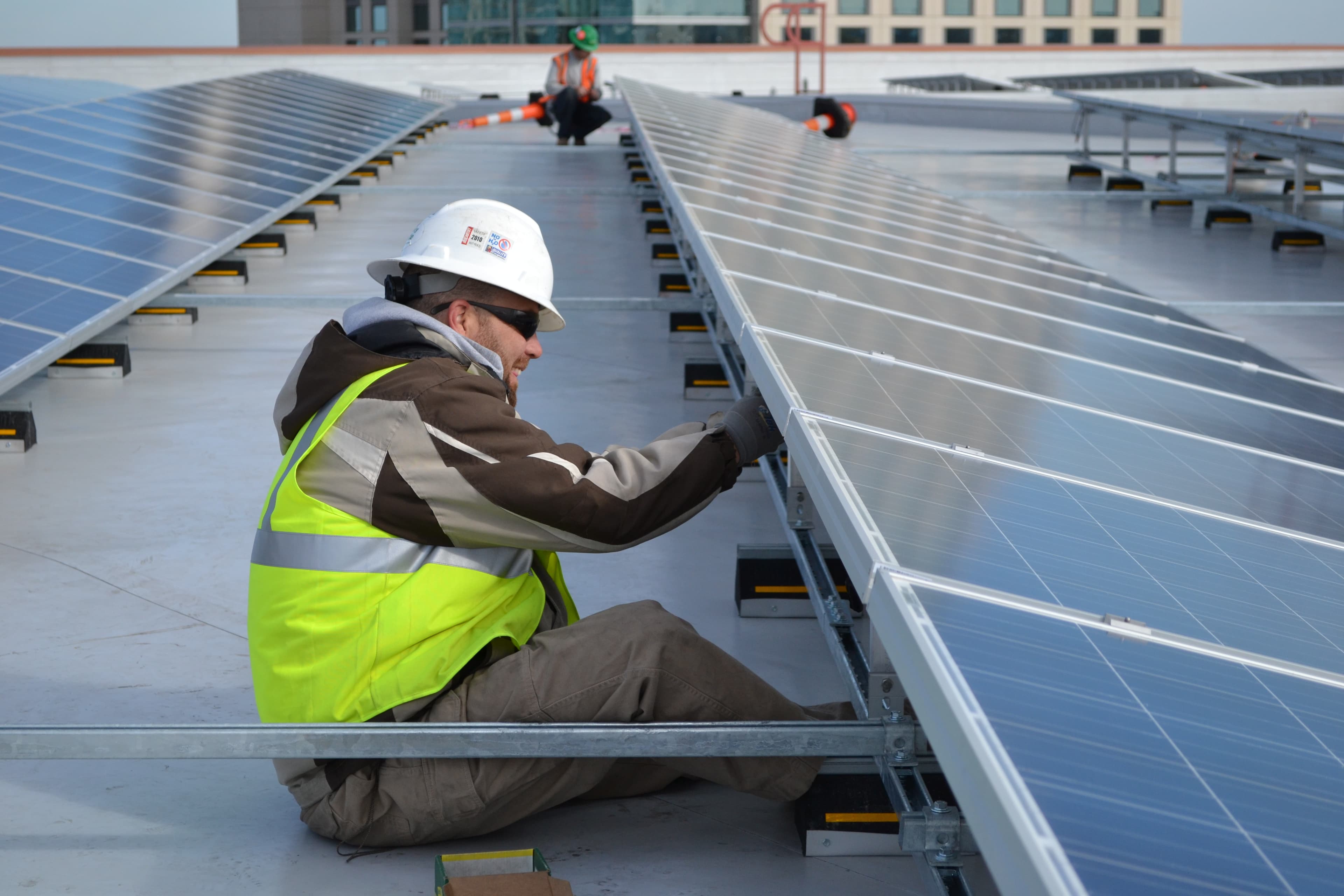 Technician installing a rooftop solar array